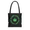 This plant lover weed leaf tote bag features a bold weed leaf design with 'Plant Lover' written around it, all in a green color same as the weed leaf itself. Weed Leaf Tote Bag is black.