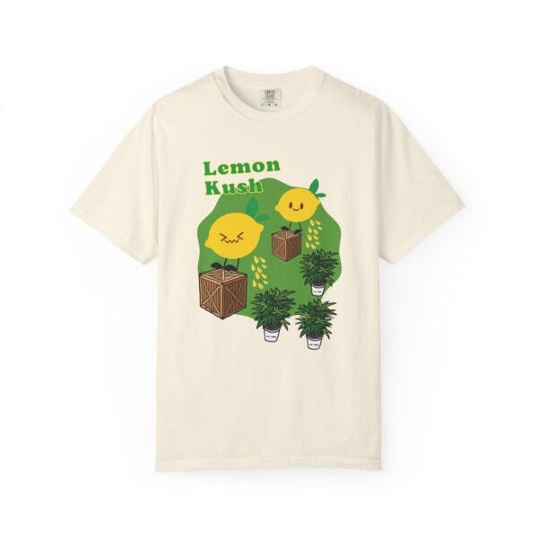 This Lemon Kush T-shirt features two weed leaves two lemons standing on boxes squirting lemon juice on weed plants like they are peeing on them. "Lemon Kush is written above the lemons with a green background.
