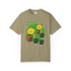 This Lemon Kush T-shirt features two weed leaves two lemons standing on boxes squirting lemon juice on weed plants like they are peeing on them. "Lemon Kush is written above the lemons with a green background.