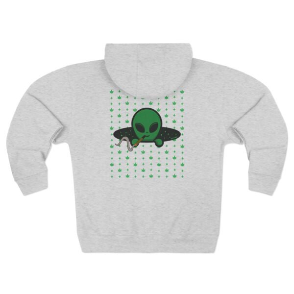 Green Alien Portal Zip up features a green alien popping out of a black hole smoking a blunt. weed pattern behind alien