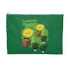 This Lemon Kush accessory pouch features two weed leaves two lemons standing on boxes squirting lemon juice on weed plants like they are peeing on them. "Lemon Kush is written above the lemons with a green background.